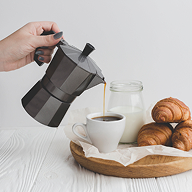 crop-hand-pouring-coffee-into-cup 1
