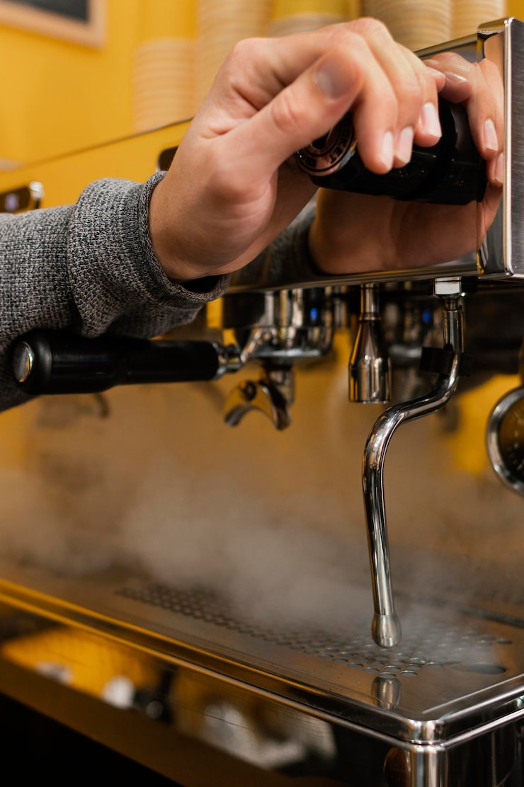 male-barista-holing-professional-coffee-machine_23-2148824383